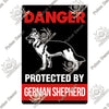 A vintage warning metal sign featuring a silhouette of a German Shepherd dog on a black background with red text reading DANG