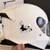 A white helmet features a black butterfly vinyl sticker decal on the side.