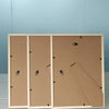 Three solid wood picture frames with acrylic fronts displayed against a light blue background.
