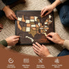 Hands assemble a custom engraved wooden USA travel map puzzle on a textured rug.