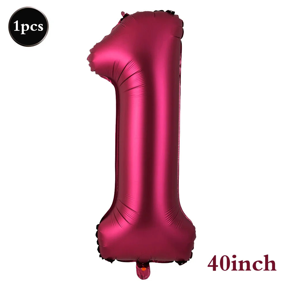 A single large, shiny magenta foil number balloon shaped like the number one.