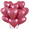 A bunch of pink heart-shaped foil balloons tied together for a party or celebration.