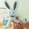 A hand is holding a light blue giant kawaii rabbit plush toy with brown accents.