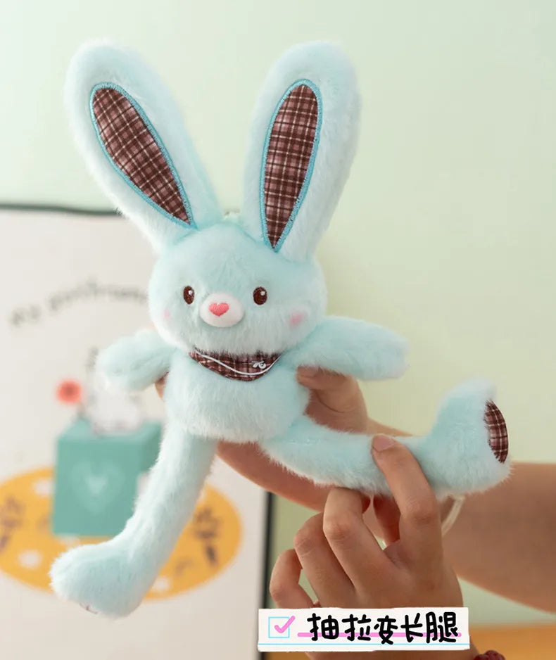A hand is holding a light blue giant kawaii rabbit plush toy with brown accents.