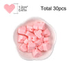 A pile of pink silicone heart beads is shown in a white dish, with a heart shape indicating the bead size.