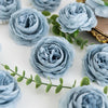A close-up of soft blue silk peony artificial flowers arranged on a white surface.