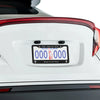 A white car's license plate frame featuring a New York plate and the text Jesus Loves You