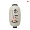 A large, cylindrical Japanese paper hanging lantern with black accents and Japanese calligraphy on the front.