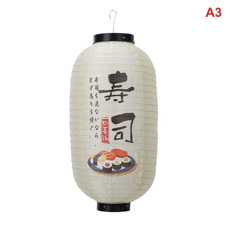 A large, cylindrical Japanese paper hanging lantern with black accents and Japanese calligraphy on the front.