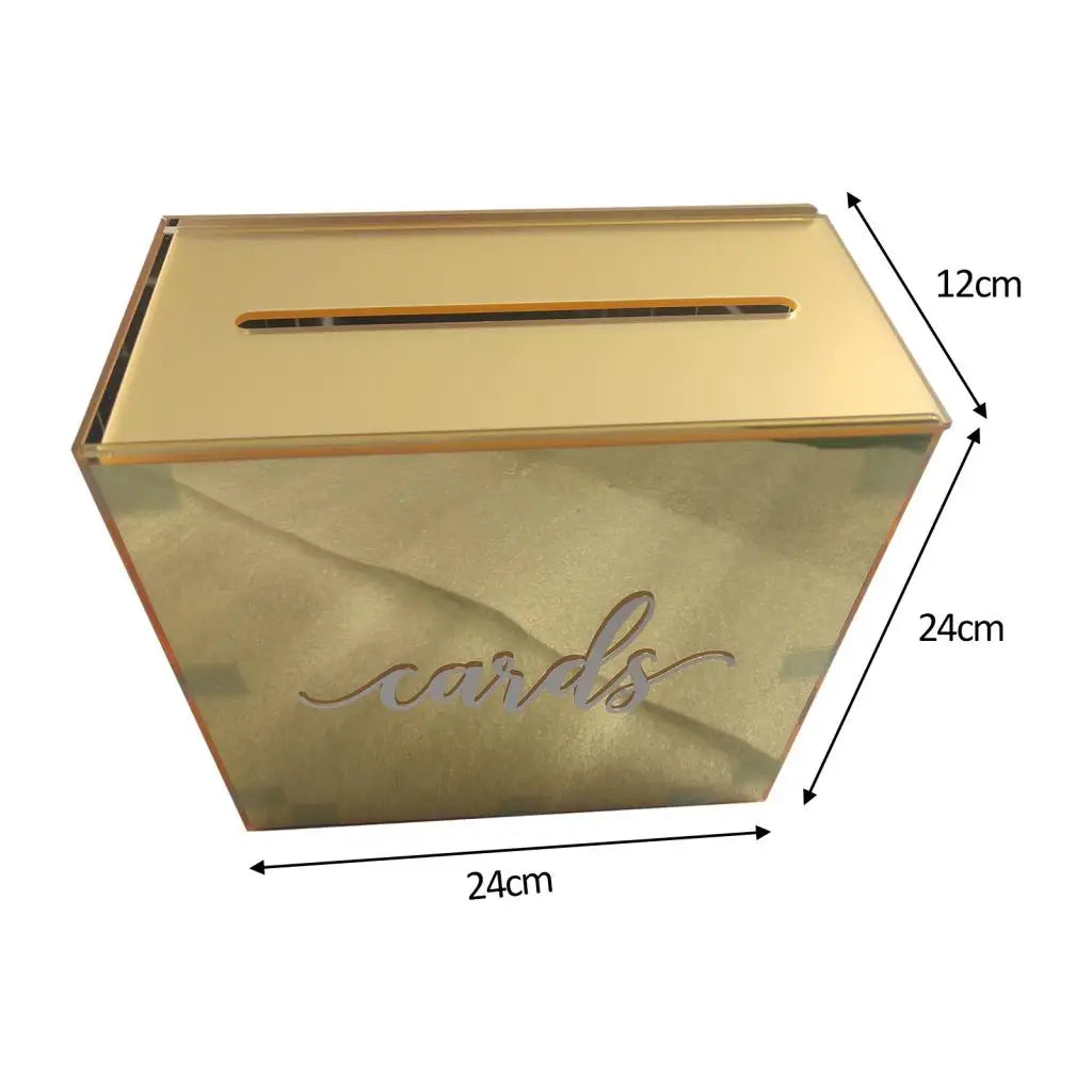 A rectangular gold-colored acrylic gift box with a slanted lid and cursive writing on the front.