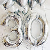 Metallic silver number foil balloons shaped like 30 for milestone celebrations