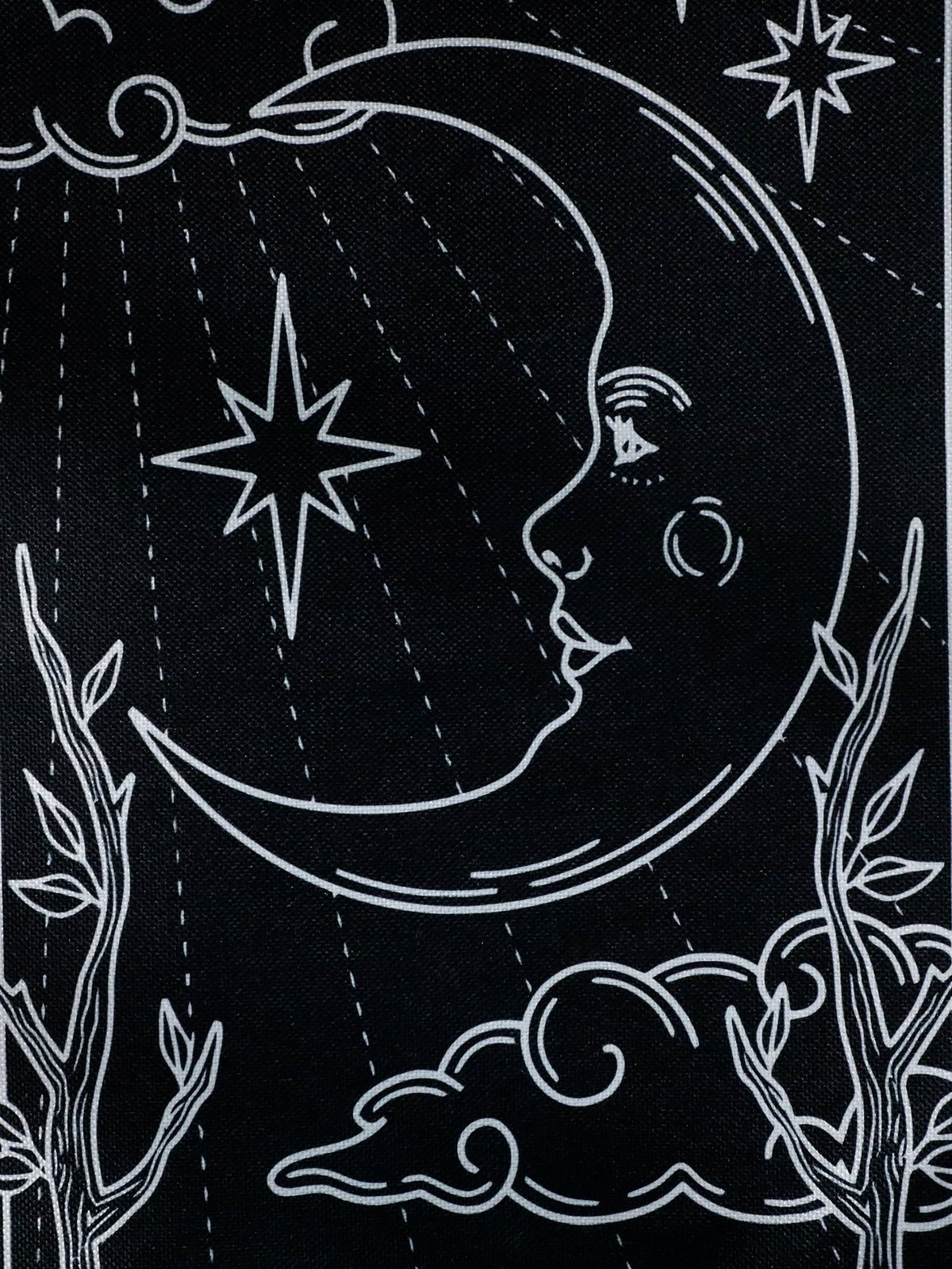 A black and white line drawing of a crescent moon, stars, and branches against a dark background.