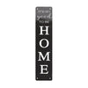 A vertical black metal sign with white text that reads It's so good to be home
