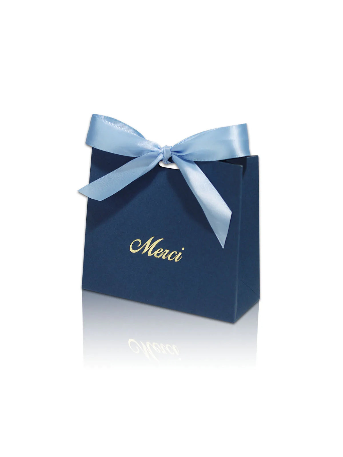 A dark blue paperboard gift bag tied with a light blue ribbon, featuring the word Merci written in gold script.