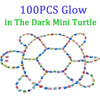 100 pieces of glow-in-the-dark resin turtle figurines in various colors forming a pattern.