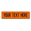 An orange rectangular sign with black text that reads YOUR TEXT HERE.