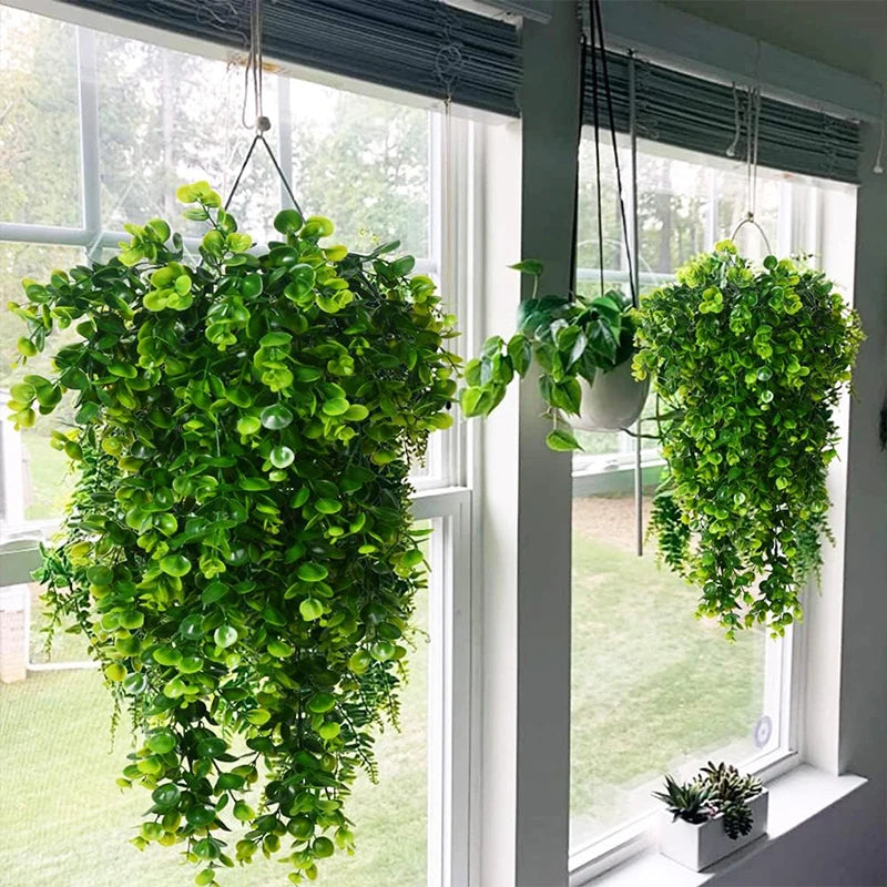 Hanging artificial eucalyptus leaf faux plants cascading from a window frame