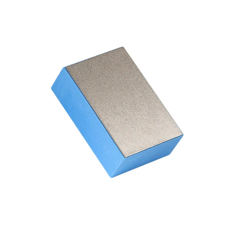 A rectangular polishing pad with a blue base and a gold textured top.