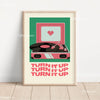 A framed canvas art print featuring a pink retro cassette player with a vinyl record and the text TURN IT UP repeated below.