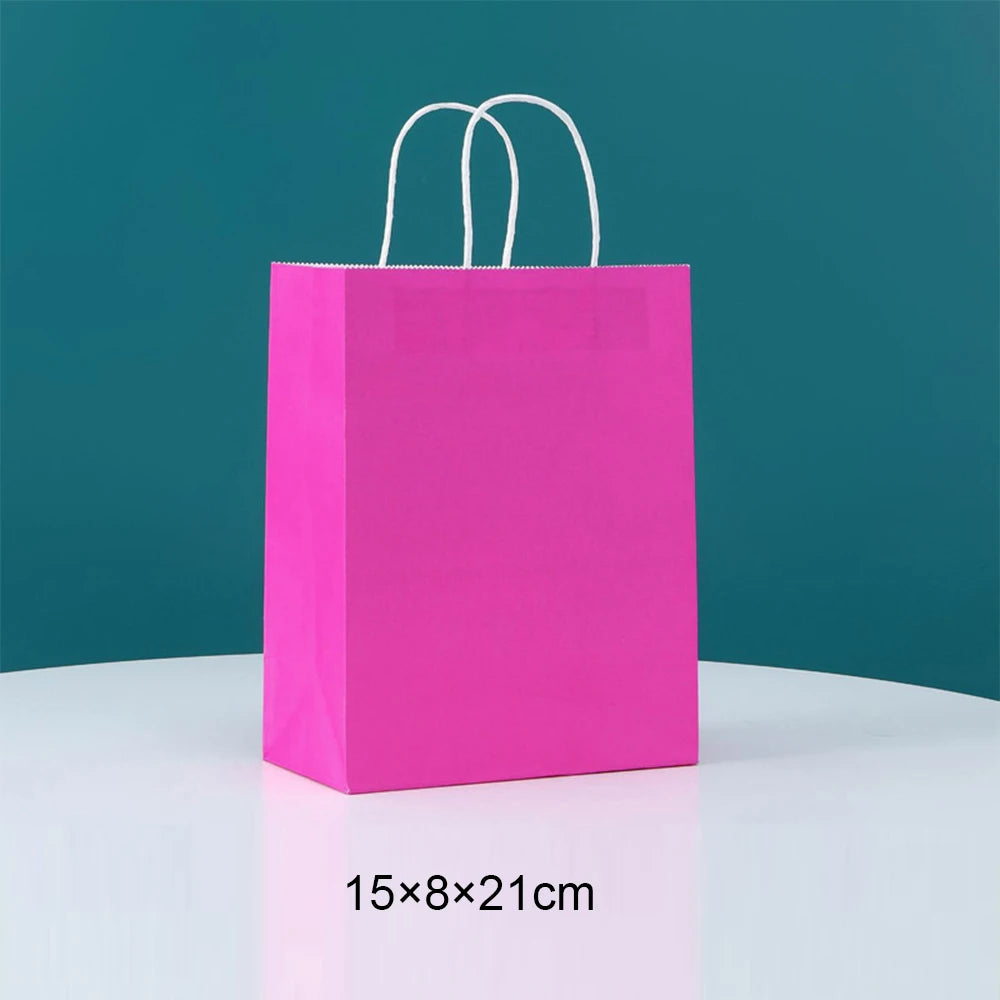 A bright pink disposable paper food tray with white handles against a teal background.