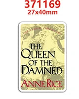 A rectangular gold-toned resin flatback charm featuring the title The Queen of the Damned by Anne Rice