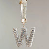 A silver letter charm shaped like a W, encrusted with clear crystals and attached to a chain.