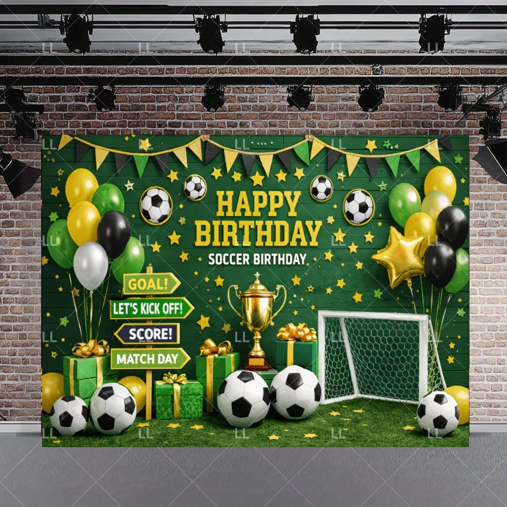 A green soccer field backdrop decorated with balloons, a trophy, and a goal net for a birthday celebration.