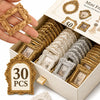A box of vintage gold and silver resin picture frames for DIY crafts and decor with a hand holding one frame