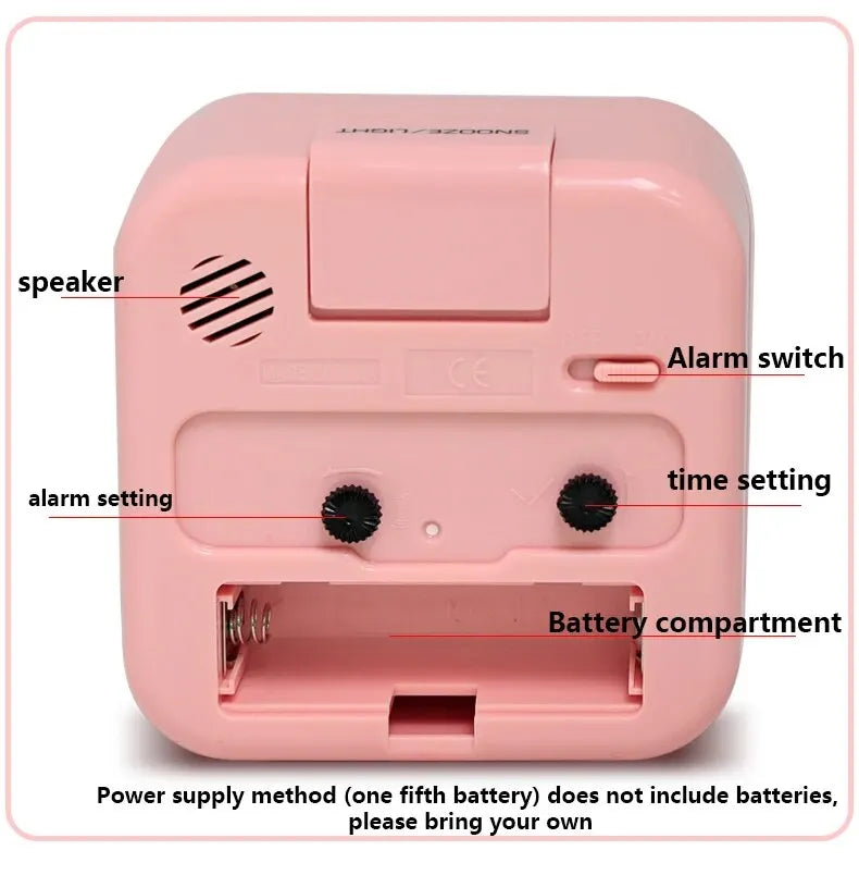 A pink compact alarm clock featuring a speaker, alarm switch, time setting, and battery compartment.