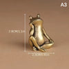 A vintage brass frog statue desktop ornament shown in a side profile against a neutral background.
