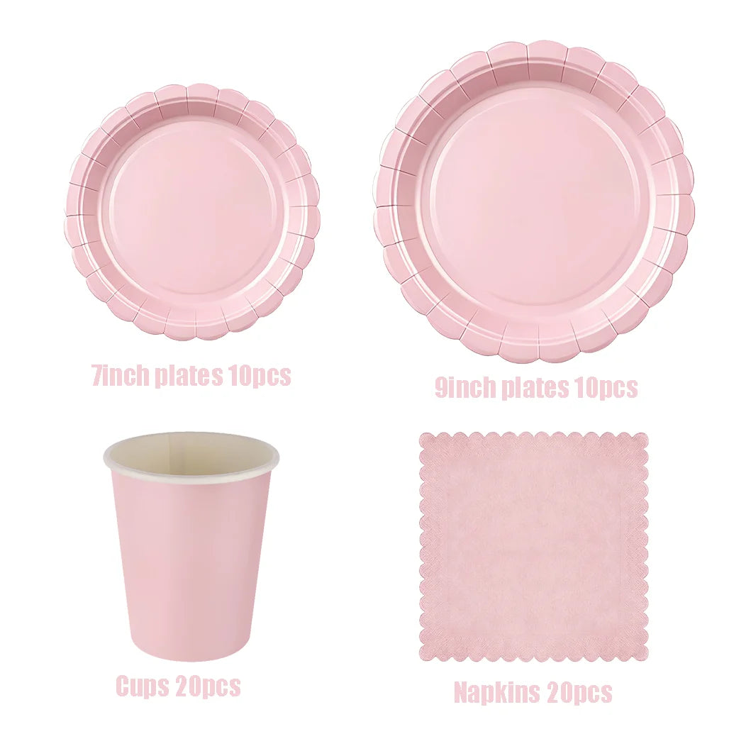 A set of pink scalloped paper tableware including 7 inch and 9 inch plates, cups, and napkins.