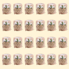 A grid of handcrafted wooden tealight candle holders with floral accents used for wedding favors and gifts.