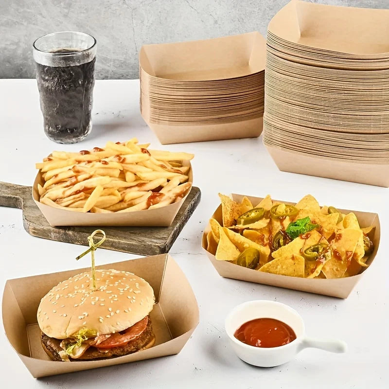 A collection of food items including french fries, nachos, and a hamburger served in kraft paper trays.