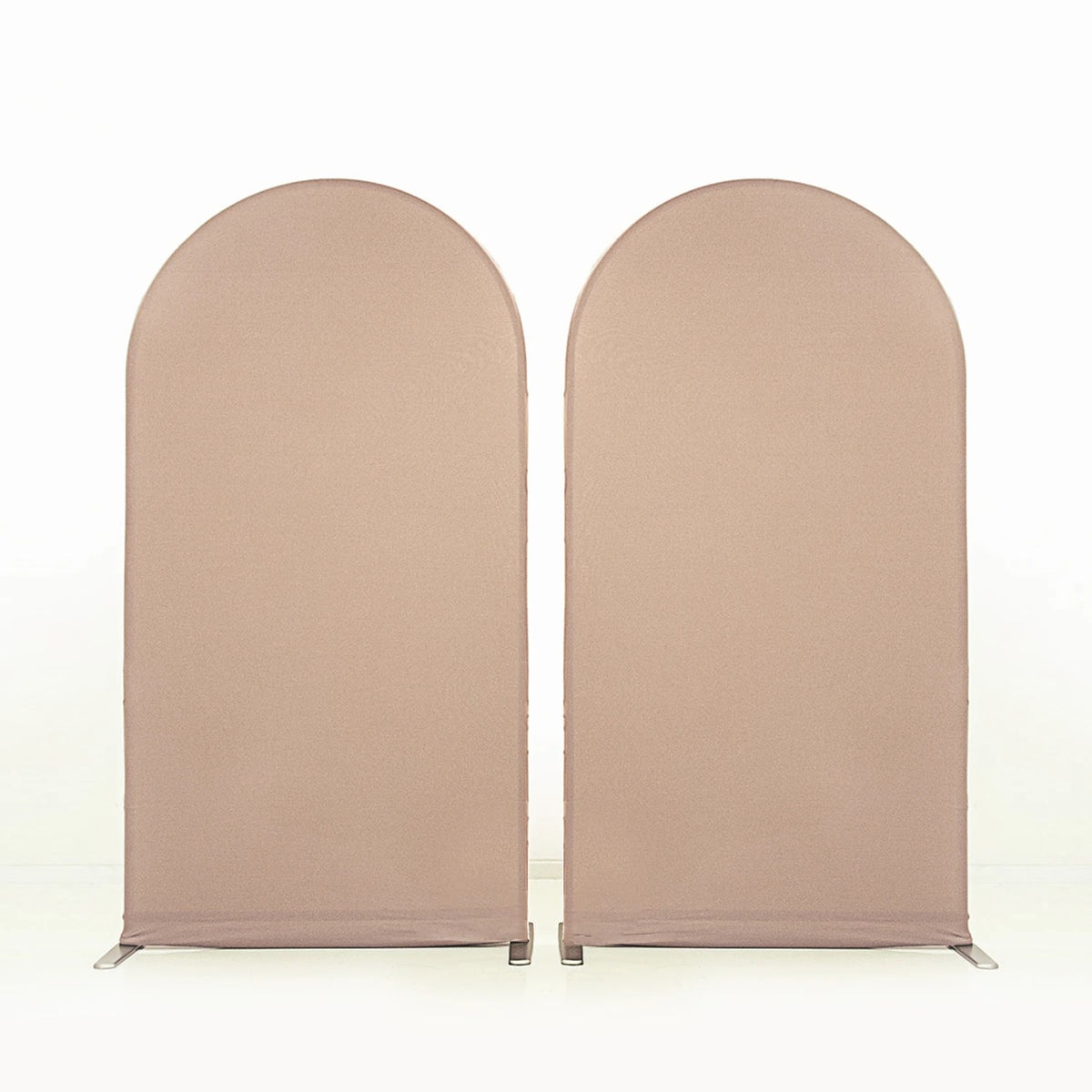 Two beige stretchable arch backdrop covers standing upright.