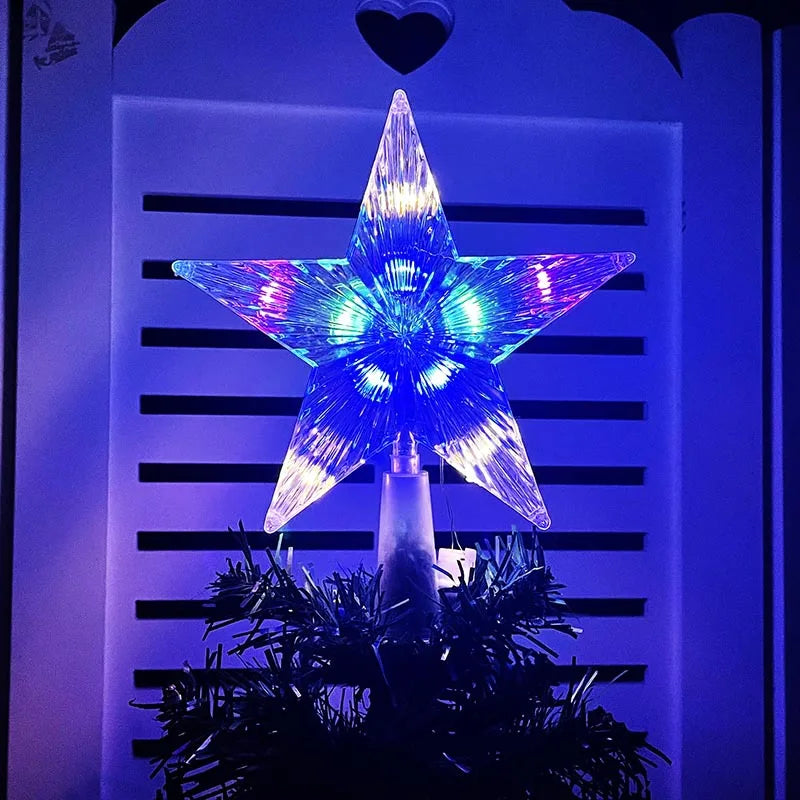 A glowing blue and purple star shaped LED Christmas tree topper displayed against a dark background.