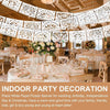 White paper picado banner for indoor party decoration featuring floral arrangements and dining tables