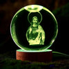 A glowing green crystal ball night light featuring a silhouette of Jesus Christ.