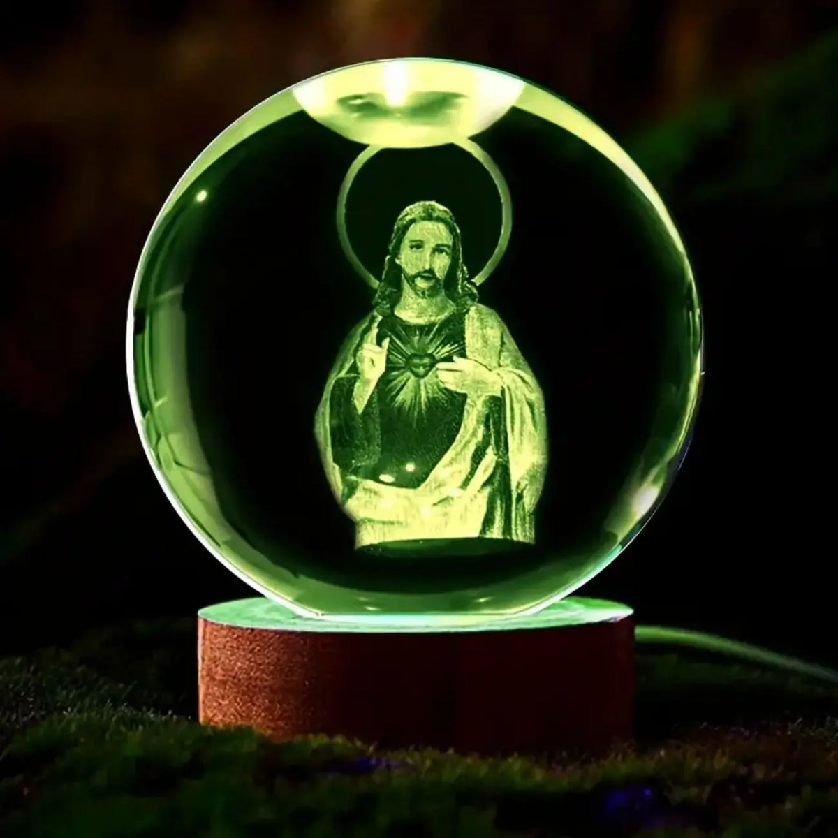 A glowing green crystal ball night light featuring a silhouette of Jesus Christ.
