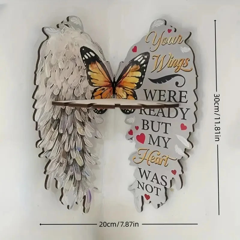 A decorative wall shelf featuring angel wings and a butterfly cutout, made of wood and crystal.