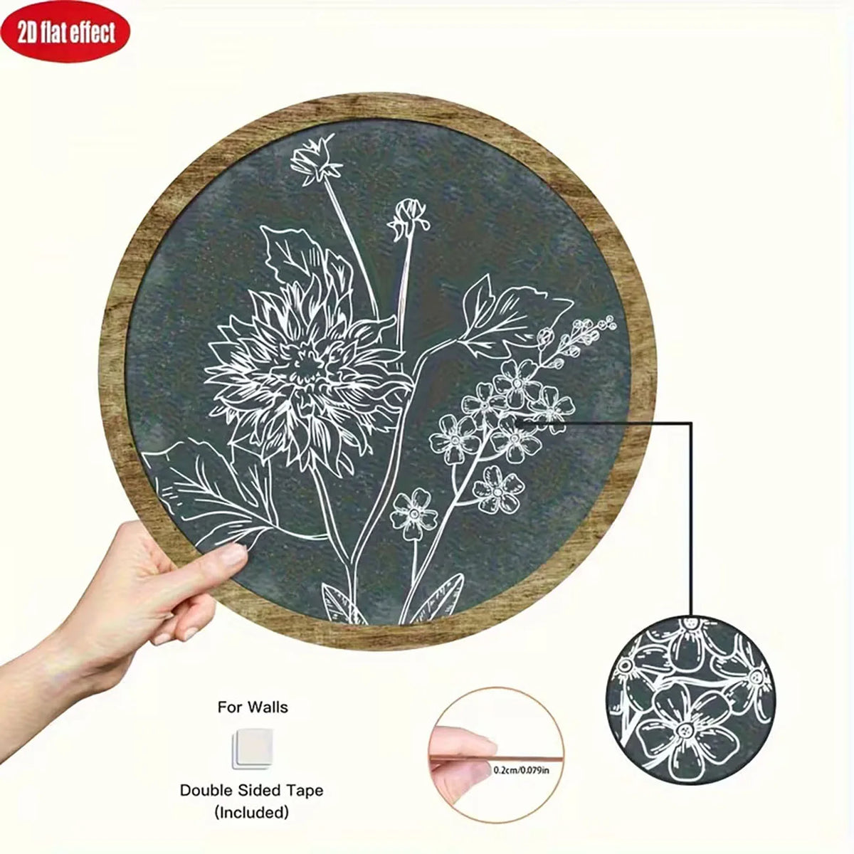 A wooden circle with a chalkboard surface featuring a white line drawing of flowers, showing the double-sided tape included.