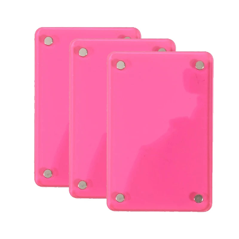 Three pink plastic photo clips used for interior decor