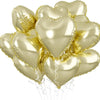 A bunch of shiny gold heart-shaped foil balloons tied together for a celebration