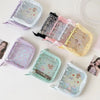 A collection of glitter star card binders in various pastel colors and designs arranged on a white surface.