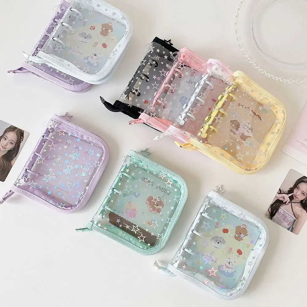A collection of glitter star card binders in various pastel colors and designs arranged on a white surface.