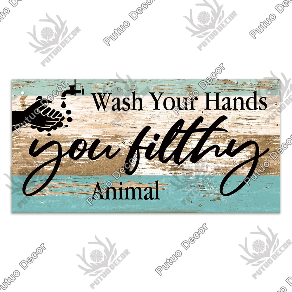 Rustic wooden sign with text instructing to wash hands and featuring an animal design.