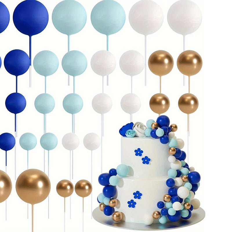 A set of 20 gold and blue ball cake toppers on sticks, including white, light blue, and navy colors.