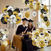A display of black, gold, and white graduation balloons featuring cap and star designs arranged in a garland.