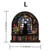 A cat-shaped wooden jigsaw puzzle featuring a cat sitting in an arched window surrounded by foliage and books.