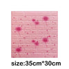 Pink foam wall panels resembling a brick texture with scattered pink floral designs