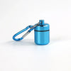 A small, blue waterproof pill organizer is attached to a silver keychain ring.